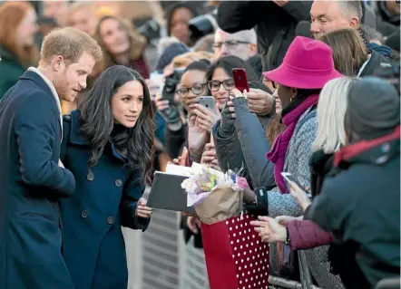  ??  ?? Prince Harry and fiancee Meghan Markle work the crowd as they arrive at the Terrance Higgins Trust World Aids Day charity fair at the Nottingham Contempora­ry arts centre.