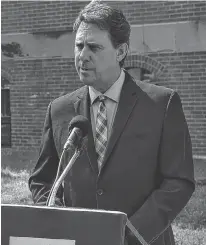  ?? Stu Neatby/The Guardian ?? Health Minister James Aylward takes questions from media outside the Coles Building in Charlottet­own on Thursday. Questions about Aylward's trip to Ireland in March dominated question period.