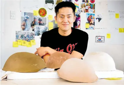  ??  ?? Artist in residence Sung Hwan Bobby Park explores the costs of conformity with his ceramic helmet project.