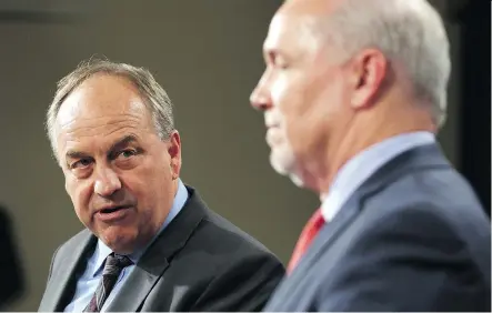  ?? CHAD HIPOLITO/THE CANADIAN PRESS ?? B.C. Green party leader Andrew Weaver, left, and B.C. Premier John Horgan last year. In a letter, Weaver says the province’s greenhouse gas reductions “must be done in a way that limits harm to other existing industries that provide jobs and economic...