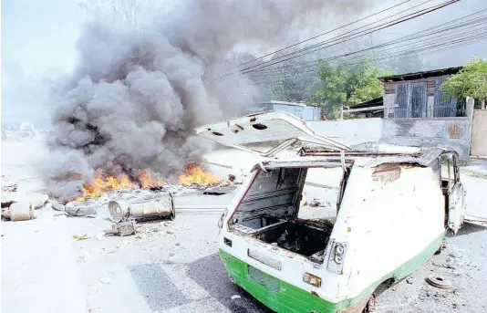  ?? FILE ?? Burning debris, demonstrat­ions, and looting were features of the 1999 gas riots.