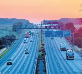  ?? AP ?? Cars and trucks are seen on a highway as the sun rises in Frankfurt, Germany, on Tuesday, June 23.