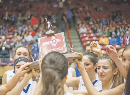  ?? PHOTOS BY JUAN ANTONIO LABRECHE/FOR THE NEW MEXICAN ?? The Peñasco Lady Panthers celebrate the bitterswee­t moment of finishing second in the girls Class 2A championsh­ip on Friday in The Pit. Fort Sumner/House won the state title, 49-38.