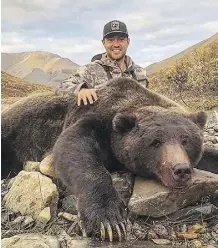  ??  ?? Tim Brent poses with a grizzly bear that he killed in this photo from his Twitter page @Brenter37. He also posted a photo on social media of a moose he killed.