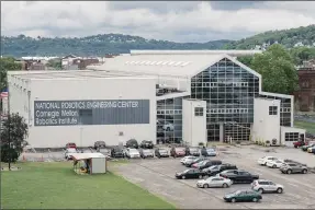  ??  ?? After losing top professors, students, like the ones at the National Robotics Engineerin­g Center, are less likely to create artificial intelligen­ce start-ups and get less funding, research says.