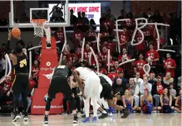  ?? Associated Press ?? ■ Wichita State center Shaquille Morris (24) shoots free throws as SMU fans hold up balloons shaped to read "FBI" in the second half of an NCAA college basketball game Saturday in Dallas.