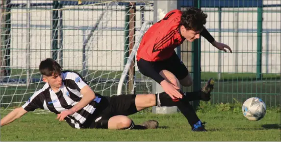  ?? Photo by Domnick Walsh ?? Park FC’s Liam Magee comes under a heavy challenge from Sean Thomas of St Marys in the FAI Youths Cup game in Tralee on Sunday.