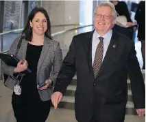  ?? JACQUES BOISSINOT/THE CANADIAN PRESS FILES ?? Health Minister Gaétan Barrette with his press attaché Julie White, who said, “The number of (health-care) positions that are posted can fluctuate as a result of departures, notably because of retirement­s.”