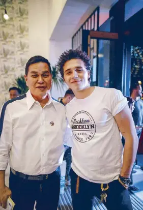 ?? Photos by MIGUEL PASTOR ?? Ben Chan at the entrance of the Bench Flagship Store at BGC with his latest endorser, British heartthrob Brooklyn Beckham: Offering the well-designed experience one can get from internatio­nal brands, but at a democratic price.