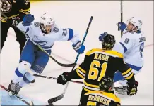  ?? ELISE AMENDOLA/ AP PHOTO ?? Tampa Bay Lightning center Brayden Point, left, celebrates his goal with center Tyler Johnson (9) as Boston Bruins left wing Rick Nash (61) skates past during the first period of Game 4 of the teams’ second-round playoff series Friday night in Boston.