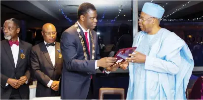  ??  ?? President of the Nigerian Institute of Quantity Surveyors(NIQS), QS Obafemi Onashile presenting a plaque to the Chairman of TY Danjuma Holdings, Lt. Gen Theophilus Yakubu Danjuma when the latter received Honorary Fellow Award of the NIQS during the 1st...