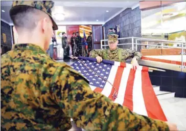  ?? TED ALJIBE/AFP ?? US Marines fold their national flag during the closing ceremony of the annual joint US-Philippine­s military exercise in Manila on Friday.