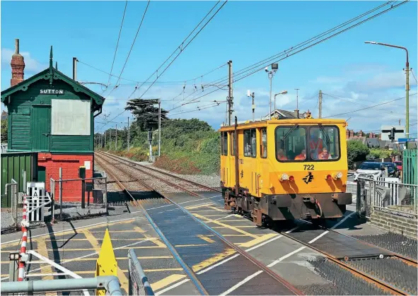  ?? ?? Inspection Car No. 722 makes an unusual appearance at Sutton station on the Howth branch, while working from North Wall-Howth on August 3. The disused signal cabin has been cosmetical­ly restored. Stephen White