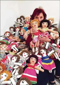  ?? YOLANDE LABAKI VIA AP ?? Lebanese painter Yolande Labaki, 93, worked diligently since the Beirut seaport blast in August, stuffing fabric with cotton and tailoring the tiny dresses for dolls at her house in Beirut in time for Christmas. The 100 dolls she created were distribute­d to children who had their lives touched by the explosion.