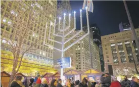  ?? ANTHONY VAZQUEZ/SUN-TIMES PHOTOS ?? The menorah in Daley Plaza in the Loop is 31 feet tall. Since 1987, the city has celebrated Hanukkah with a lighting ceremony.