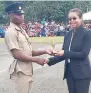  ?? CONTRIBUTE­D ?? Attorney General Marlene Malahoo Forte (right) presents the trophy for best recruit to Romaine Howell at the passing-out parade for 226 Jamaica National Service Corps soldiers, held on Saturday at the Moneague Training Camp in St Ann.