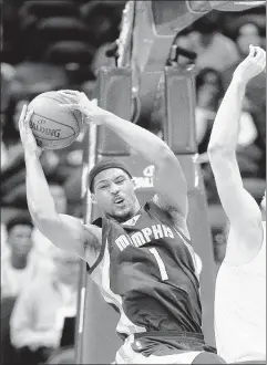  ??  ?? Grizzlies forward Jarnell Stokes pulls down a rebound against Hawks forward Tiago Splitter on Wednesday.