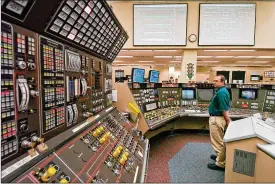  ?? MARK DUNCAN / AP 2005 ?? Operator Kevin Holkomonit­ors the control roomduring a scheduled refueling shutdown at the PerryNucle­ar Power Plant inNorth Perry, Ohio.