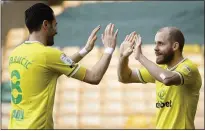  ??  ?? HELPING HAND: Teemu Pukki (right) celebrates his goal