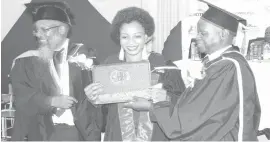  ??  ?? Brenda Ncube receives her certificat­e from Deputy Director in Polytech Education in the Ministry of Higher and Tertiary Education, Science and Technology Developmen­t Mr Cyprion Kent Masocha (right) at a graduation ceremony at Bulawayo Polytechni­c yesterday. On the left is college principal Mr Gilbert Mabasa (Picture by Temba Dube)