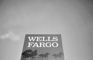  ??  ?? A Wells Fargo branch is seen in the Chicago suburb of Evanston, Illinois. A California judge has granted a preliminar­y approval for Wells Fargo & Co’s agreement to pay US$142 million, and perhaps more, to customers whose credit scores were harmed by...