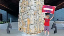  ?? NYT ?? Harrison Shaffer, 3, plays with a "vote here" sign at the Johnson County Museum in Kansas.