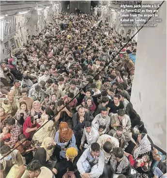  ?? CAPT. CHRIS HERBERT/U.S. AIR FORCE VIA AP ?? Afghans pack inside a U.S. Air Force C-17 as they are taken from the airport in Kabul on Sunday.