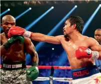  ?? AFP ?? Manny Pacquiao hits a punch to the head of Timothy Bradley. —