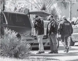  ?? PEDRO PORTAL pportal@miamiheral­d.com ?? Authoritie­s take pictures of former state Sen. Frank Artiles’ vehicle as they raid his home in Palmetto Bay on Wednesday.