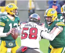  ?? - AFP photo ?? Rodgers (left) looks to pass during the NFC Championsh­ip game against the Tampa Bay Buccaneers.