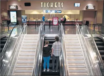  ?? E. JASONWAMBS­GANS/CHICAGO TRIBUNE PHOTOS ?? Moviegoers enter AMC River East theater in downtown Chicago on Thursday.