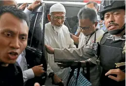  ?? PHOTO: AP ?? Ailing radical cleric Abu Bakar Bashir, centre, arrives for medical treatment at Cipto Mangunkusu­mo Hospital in Jakarta, Indonesia.