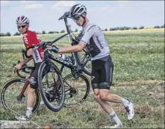  ?? Jeff Pachoud / Associated Press ?? Chris Froome, right, and Jasper De Buys get back on the road after crashing in the first stage of the Tour de France.