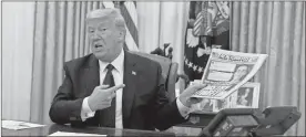  ??  ?? President Donald Trump holds up a copy of the New York Post as he speaks before signing an executive order aimed at curbing protection­s for social media giants.
