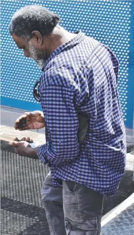  ?? Picture: CAMERON BATES ?? REPEAT OFFENDER: Timacoy Nolan Bamaga, 52, entering the Ingham Magistrate­s Court (left) on July 30 and being led to jail (right).