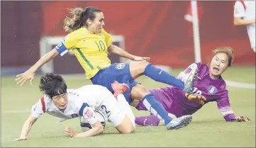  ??  ?? Brazil’s Marta is denied by South Korea’s Lee Eunmi (left) and Kim Jungmi during a Group E match at the 2015 FIFA Women’s World Cup at the Olympic Stadium in Montreal, in this June 9, 2015 file photo. — AFP photo