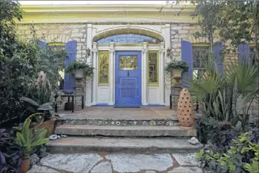  ??  ?? The front door of Jennifer Myers’ 140-year-old stone house is surrounded by a dramatic garden.