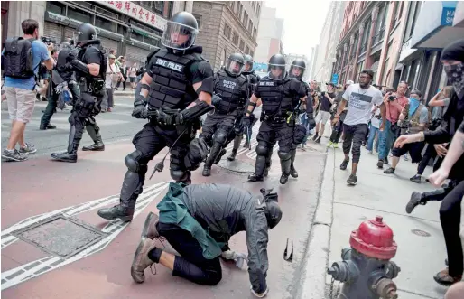  ?? AFP ?? Counterpro­testers of the Boston ‘Free Speech’ Rally clash with police as they are moved back at Boston Commons in Boston. —