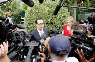  ??  ?? US TREASURY Secretary Steven Mnuchin speaks with reporters as he departs the North Lawn after speaking live with Fox and Friends TV show from the White House in Washington on June 27.