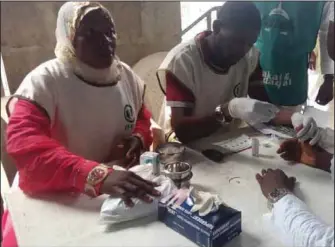  ??  ?? Medical personnel attending to a beneficiar­y at the Amuwo-Odofin outreach…recently