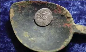  ??  ?? A 17th-century Arabian silver coin that research shows was struck in 1693 in Yemen. Photograph: Steven Senne/AP