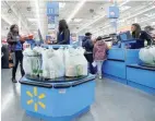  ?? — Reuters ?? Customers complete their purchases ahead of Black Friday at a Walmart store in Chicago, Illinois, US.