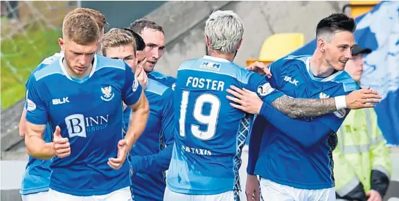  ?? SNS. ?? Scott Tanser, right, celebrates scoring against Motherwell. The Saints defender has now made 100 appearance­s for the Perth men.