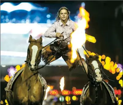  ?? Photo courtesy Kelsey Yule. ?? Piper Yule Roman rides, standing on the backs of two horses as they gallop around the arena. She and brother Cash Yule are the entertainm­ent for this year’s NDWS Rodeo, to be held March 10-11.