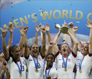  ?? ALESSANDRA TARANTINO, FILE - THE ASSOCIATED PRESS ?? United States’ Megan Rapinoe lifts up the trophy after winning the Women’s World Cup final soccer match between US and The Netherland­s at the Stade de Lyon in Decines, outside Lyon, France, in July 7, 2019. The U.S. Soccer Federation reached milestone agreements to pay its men’s and women’s teams equally, making the American national governing body the first in the sport to promise both sexes matching money.
