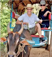  ??  ?? Tourists enjoying a ride on a bullock cart