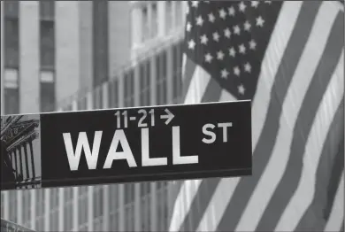  ??  ?? American flags fly at the New York Stock Exchange on Wall Street. Asian stock markets held fairly steady Friday,holding on to gains in the week driven by U.S. and Japanese central bank policy decisions that fueled investors' belief that low rates will...