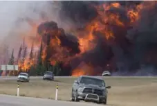  ?? JONATHAN HAYWARD/THE CANADIAN PRESS FILE PHOTO ?? A recent negative effect of climate change were the wildfires in Alberta, which slashed Canadian economic growth by 1 per cent, Timothy Lane says.