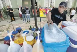  ?? Francine Orr Los Angeles Times ?? ALEX RAMIREZ sells shave ice and fruit near where his son, Benjamin, has had run-ins with a man and a woman. “I told him: Next time, get it on video.”