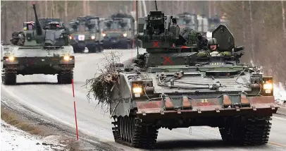  ?? ?? Ready to roll: Swedish tanks taking part in an exercise with Nato troops in March